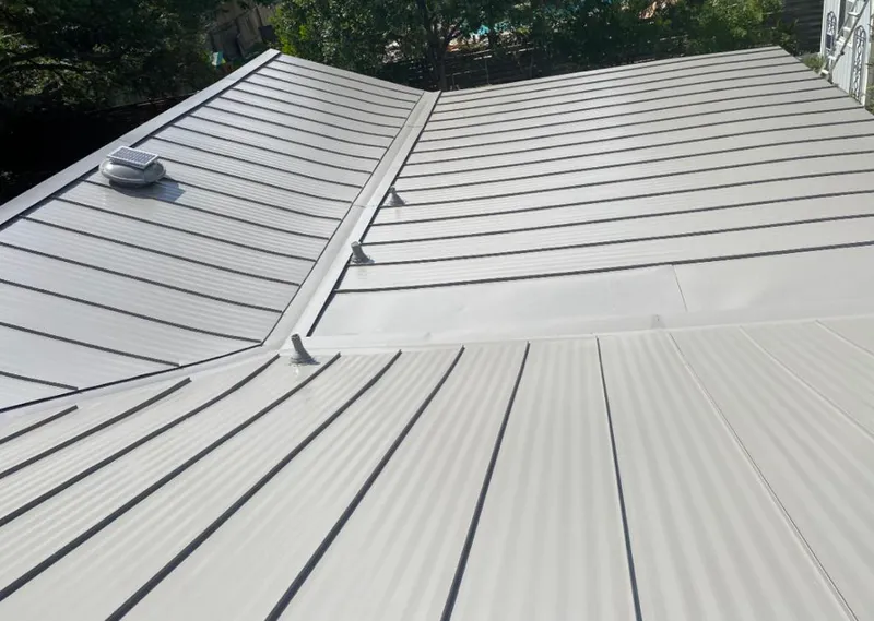 Solar attic fan installed on a metal roof for Roof Ventilation in Dallas